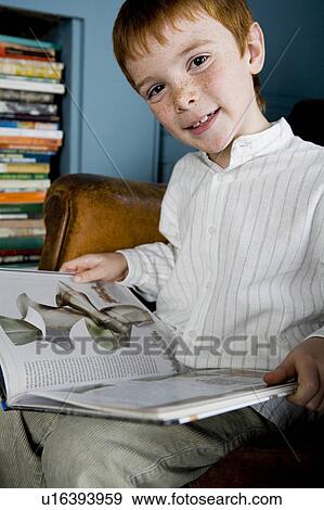Stock Photo - boy looking at book. Fotosearch