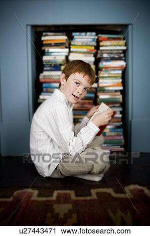 boy reading book sitting on the floor View Large Photo Image Stock Image - boy reading book sitting on the floor. Fotosearch
