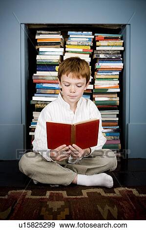 boy reading book sitting on the floor View Large Photo Image Stock Photo - boy reading book sitting on the floor. Fotosearch