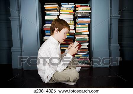 boy reading book sitting on the floor View Large Photo Image Stock Photography - boy reading book sitting on the floor. Fotosearch