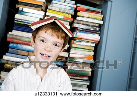 Stock Image - boy with book on his head. Fotosearch