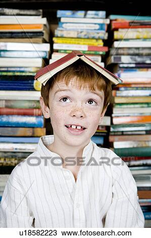 boy with book on his head View Large Photo Image Stock Image - boy with book on his head. Fotosearch