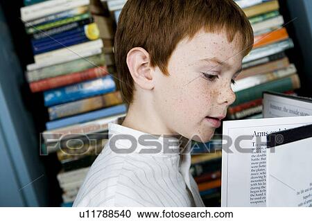 boy with ginger hair reading book View Large Photo Image Stock Image - boy with ginger hair reading book. Fotosearch