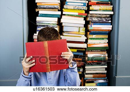 little boy hiding behind a book View Large Photo Image Stock Image - little boy hiding behind a book. Fotosearch