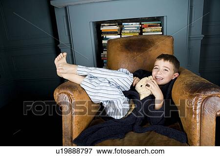 little boy in pajamas lying in chair View Large Photo Image Stock Photo - little boy in pajamas lying in chair. Fotosearch