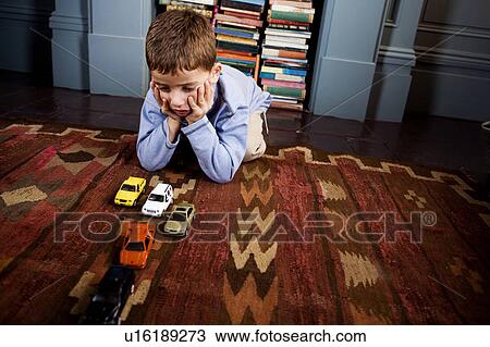 little boy playing with toy cars on the floor View Large Photo Image Stock Image - little boy playing with toy cars on the floor. Fotosearch