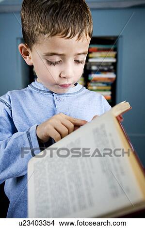 Picture - little boy reading book. Fotosearch