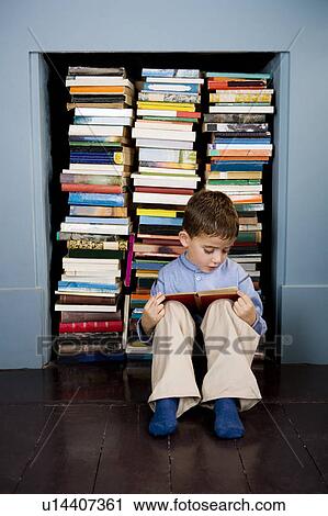 little boy reading book sitting on the floor View Large Photo Image Stock Image - little boy reading book sitting on the floor. Fotosearch
