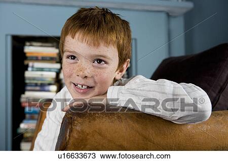 portrait boy leaning on arm of sofa View Large Photo Image Stock Image - portrait boy leaning on arm of sofa. Fotosearch