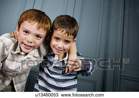 two boys with arms around each other's shoulders View Large Photo Image Stock Image - two boys with arms around each other's shoulders. Fotosearch