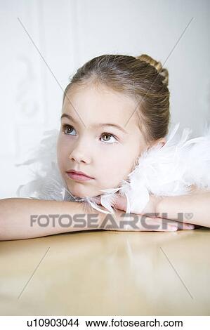 Portrait of a young girl with a feather boa in dressing up clothes View Large Photo Image Picture - Portrait of a young girl with a feather boa in dressing up clothes. Fotosearch