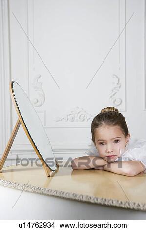 Picture - Portrait of a young girl with a feather boa in dressing up clothes. Fotosearch