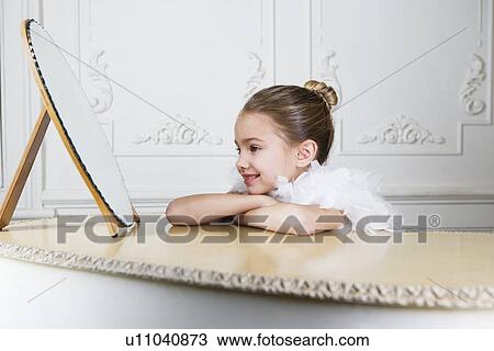 Portrait of a young girl with a feather boa in dressing up clothes View Large Photo Image Stock Image - Portrait of a young girl with a feather boa in dressing up clothes. Fotosearch
