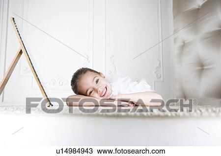 Portrait of a young girl with a feather boa in dressing up clothes View Large Photo Image Stock Image - Portrait of a young girl with a feather boa in dressing up clothes. Fotosearch