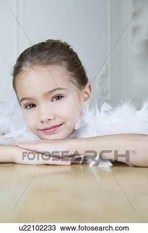 Portrait of a young girl with a feather boa in dressing up clothes View Large Photo Image Stock Image - Portrait of a young girl with a feather boa in dressing up clothes. Fotosearch