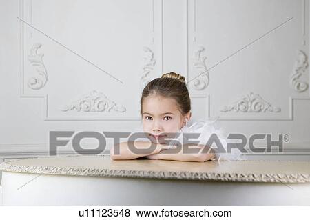 Portrait of a young girl with a feather boa in dressing up clothes View Large Photo Image Stock Photo - Portrait of a young girl with a feather boa in dressing up clothes. Fotosearch