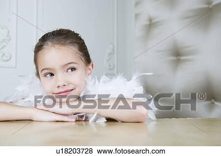 Portrait of a young girl with a feather boa in dressing up clothes View Large Photo Image Stock Photo - Portrait of a young girl with a feather boa in dressing up clothes. Fotosearch