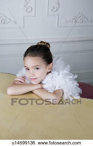Portrait of a young girl with a feather boa in dressing up clothes View Large Photo Image Stock Photograph - Portrait of a young girl with a feather boa in dressing up clothes. Fotosearch