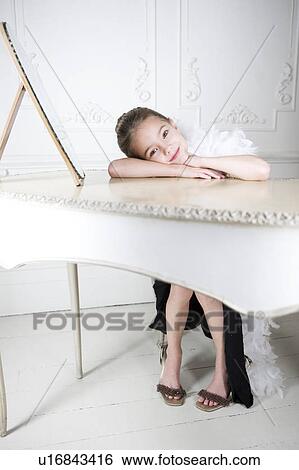 Portrait of a young girl with a feather boa in dressing up clothes View Large Photo Image Stock Photograph - Portrait of a young girl with a feather boa in dressing up clothes. Fotosearch