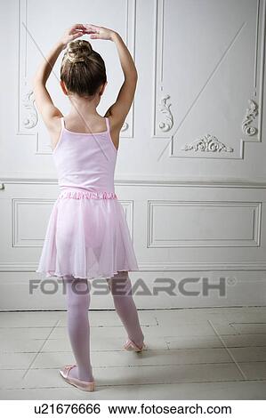 Stock Photograph - Young girl performing a ballet move . Fotosearch