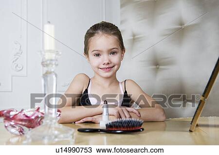 Stock Image - Young girl playing at dressing up . Fotosearch