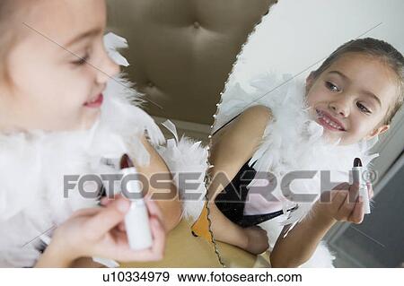 Stock Photo - Young girl playing at dressing up . Fotosearch