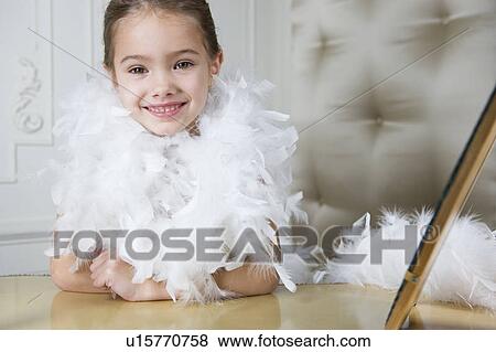 Stock Photo - Young girl playing at dressing up . Fotosearch