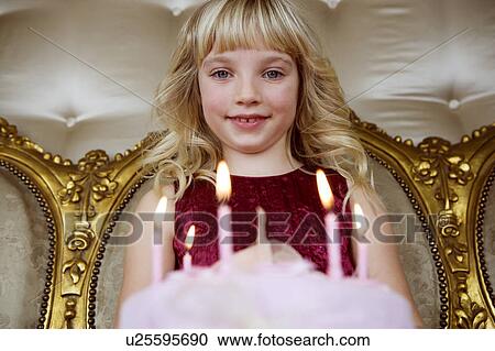 Little girl holding a birthday cake with lit candles View Large Photo Image Stock Image - Little girl holding a birthday cake with lit candles. Fotosearch