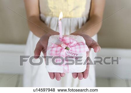 Little girl holding a birthday cake with lit candles View Large Photo Image Stock Photo - Little girl holding a birthday cake with lit candles. Fotosearch