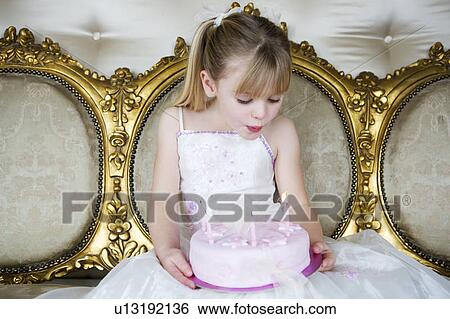 Little girl holding a birthday cake with lit candles View Large Photo Image Stock Photograph - Little girl holding a birthday cake with lit candles. Fotosearch