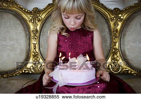 Little girl holding a birthday cake with lit candles View Large Photo Image Stock Photography - Little girl holding a birthday cake with lit candles. Fotosearch