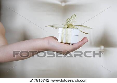 Little girl holding a present, close up View Large Photo Image Stock Image - Little girl holding a present, close up. Fotosearch