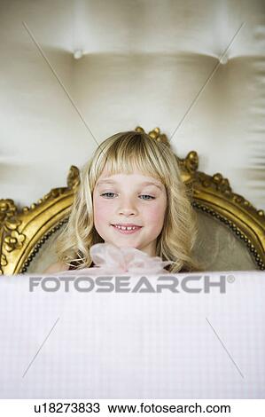 Stock Image - Little girl holding her Birthday present . Fotosearch