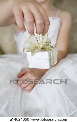 Little girl holding out a birthday present View Large Photo Image Stock Image - Little girl holding out a birthday present . Fotosearch