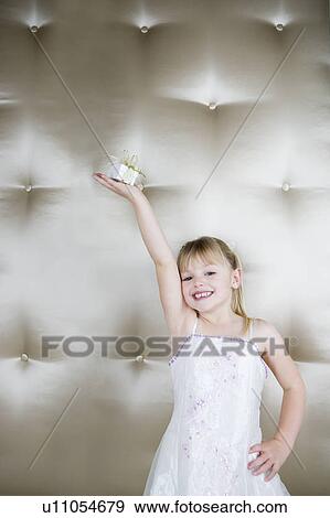 Stock Photo - Little girl holding up a present. Fotosearch