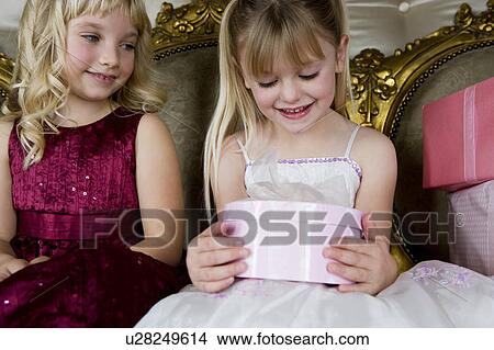 Little girls sharing birthday presents View Large Photo Image Picture - Little girls sharing birthday presents. Fotosearch