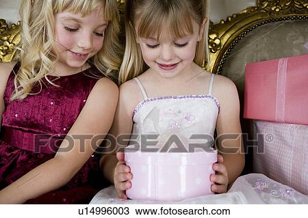 Little girls sharing birthday presents View Large Photo Image Stock Image - Little girls sharing birthday presents. Fotosearch