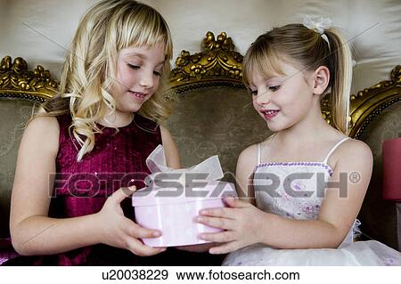Little girls sharing birthday presents View Large Photo Image Stock Photo - Little girls sharing birthday presents. Fotosearch