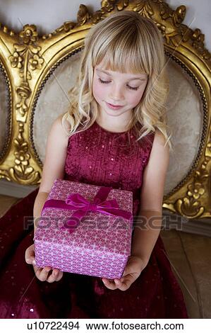 Portrait of a little girl holding birthday presents View Large Photo Image Picture - Portrait of a little girl holding birthday presents. Fotosearch