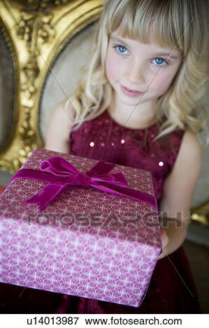 Portrait of a little girl holding birthday presents View Large Photo Image Stock Photo - Portrait of a little girl holding birthday presents. Fotosearch