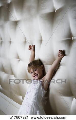 Little girl in a party dress, arms outstretched, View Large Photo Image Stock Image - Little girl in a party dress, arms outstretched, . Fotosearch