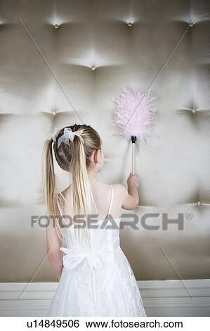 Little girl in a party dress holding a pink feather duster  View Large Photo Image Stock Photograph - Little girl in a party dress holding a pink feather duster . Fotosearch