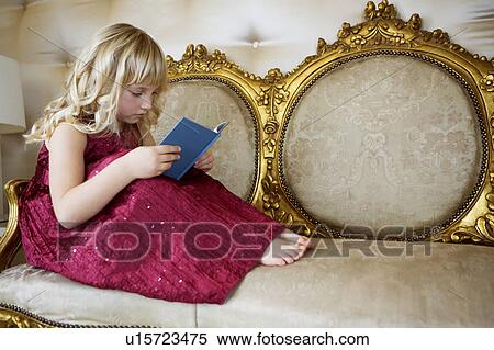 Little girl in a party dress, reading a book View Large Photo Image Stock Photography - Little girl in a party dress, reading a book. Fotosearch