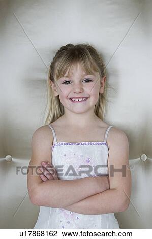 Little girl with folded arms wearing a party dress View Large Photo Image Stock Image - Little girl with folded arms wearing a party dress . Fotosearch