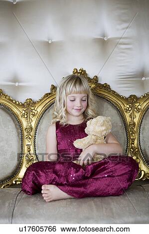 Portrait of a little girl holding a teddy bear View Large Photo Image Stock Photograph - Portrait of a little girl holding a teddy bear. Fotosearch