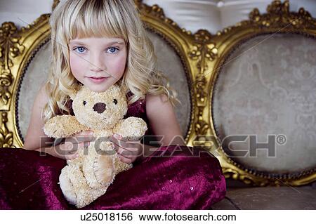 Portrait of a little girl holding a teddy bear View Large Photo Image Stock Photograph - Portrait of a little girl holding a teddy bear. Fotosearch