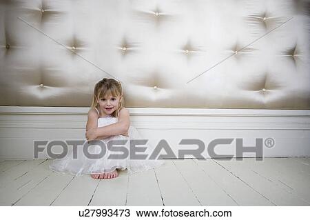 Portrait of a little girl in party dress sitting on the floor View Large Photo Image Stock Image - Portrait of a little girl in party dress sitting on the floor. Fotosearch