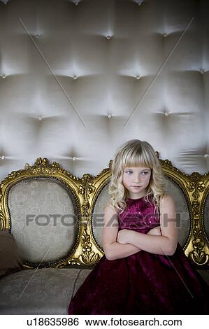 Young girl in a party dress looking bored and unhappy View Large Photo Image Stock Photograph - Young girl in a party dress looking bored and unhappy. Fotosearch