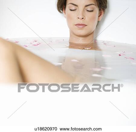 Stock Image - A young woman in a spa bath. Fotosearch