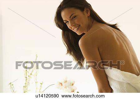 Stock Image - A young woman wrapped in a bath towel. Fotosearch